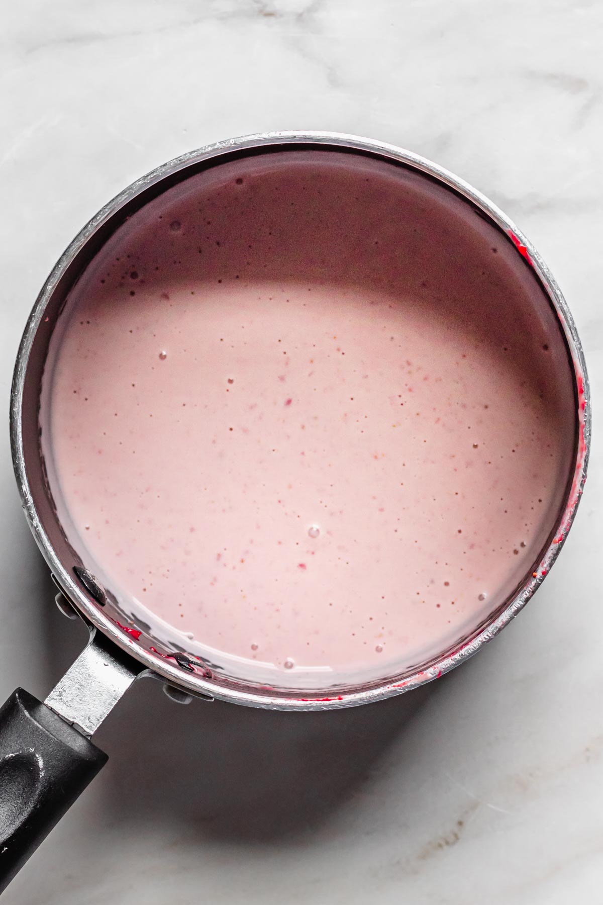 Light pink heavy cream in the saucepan.