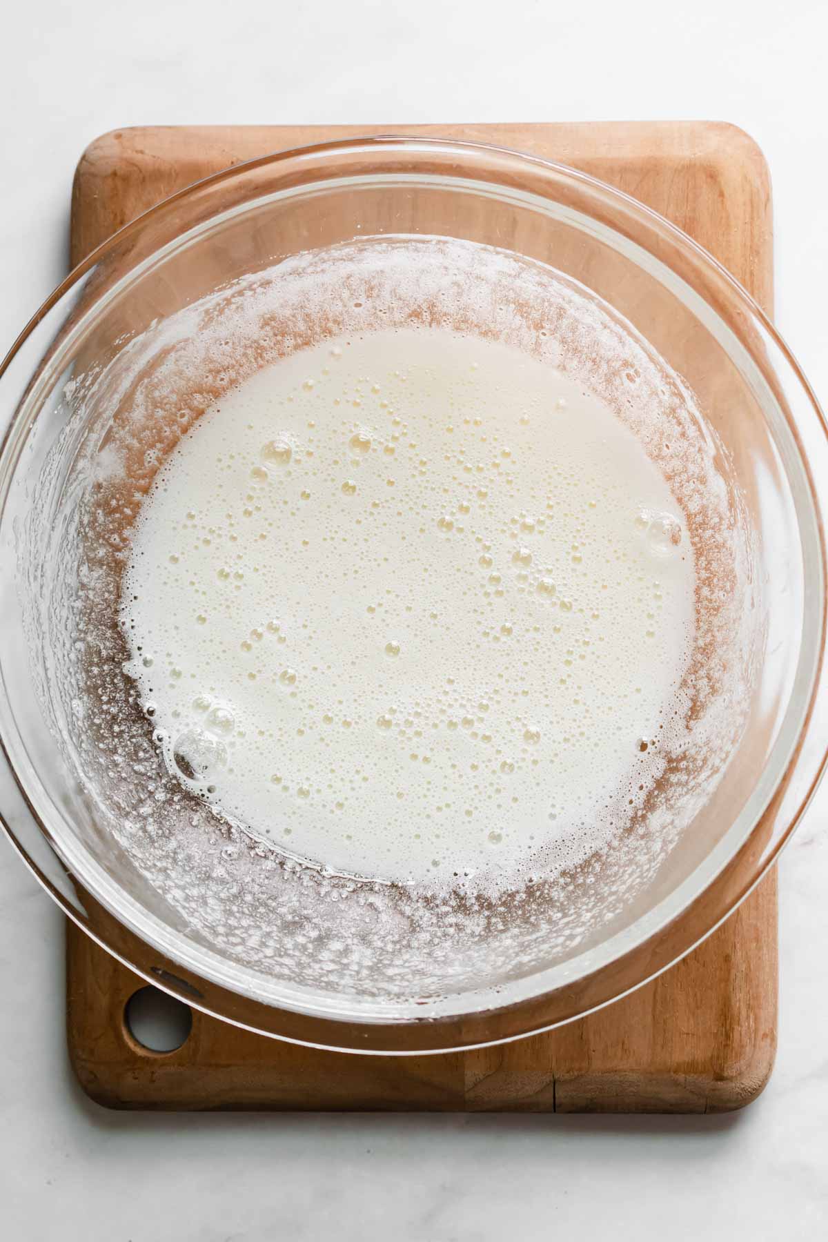 Heated and whisked egg whites and sugar in a bowl.