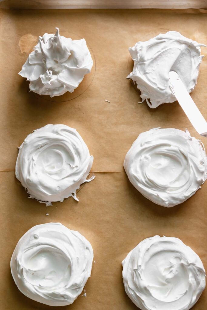 An offset spatula moves the meringue down into circles and makes swoops in the center. 