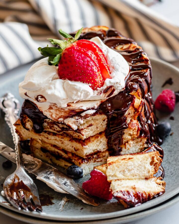 Stack of French toast with a slice removed.