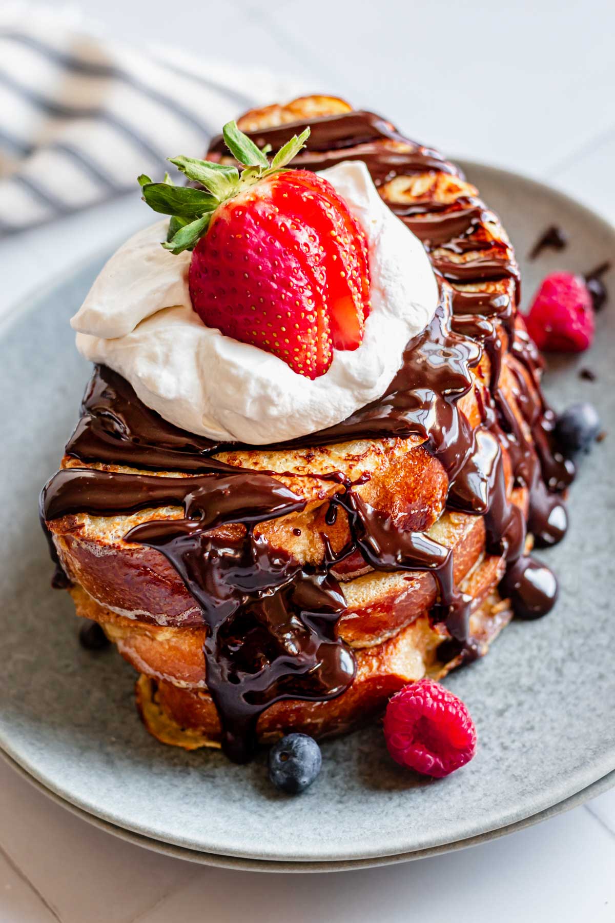 Stack of baileys French toast fully decorated.