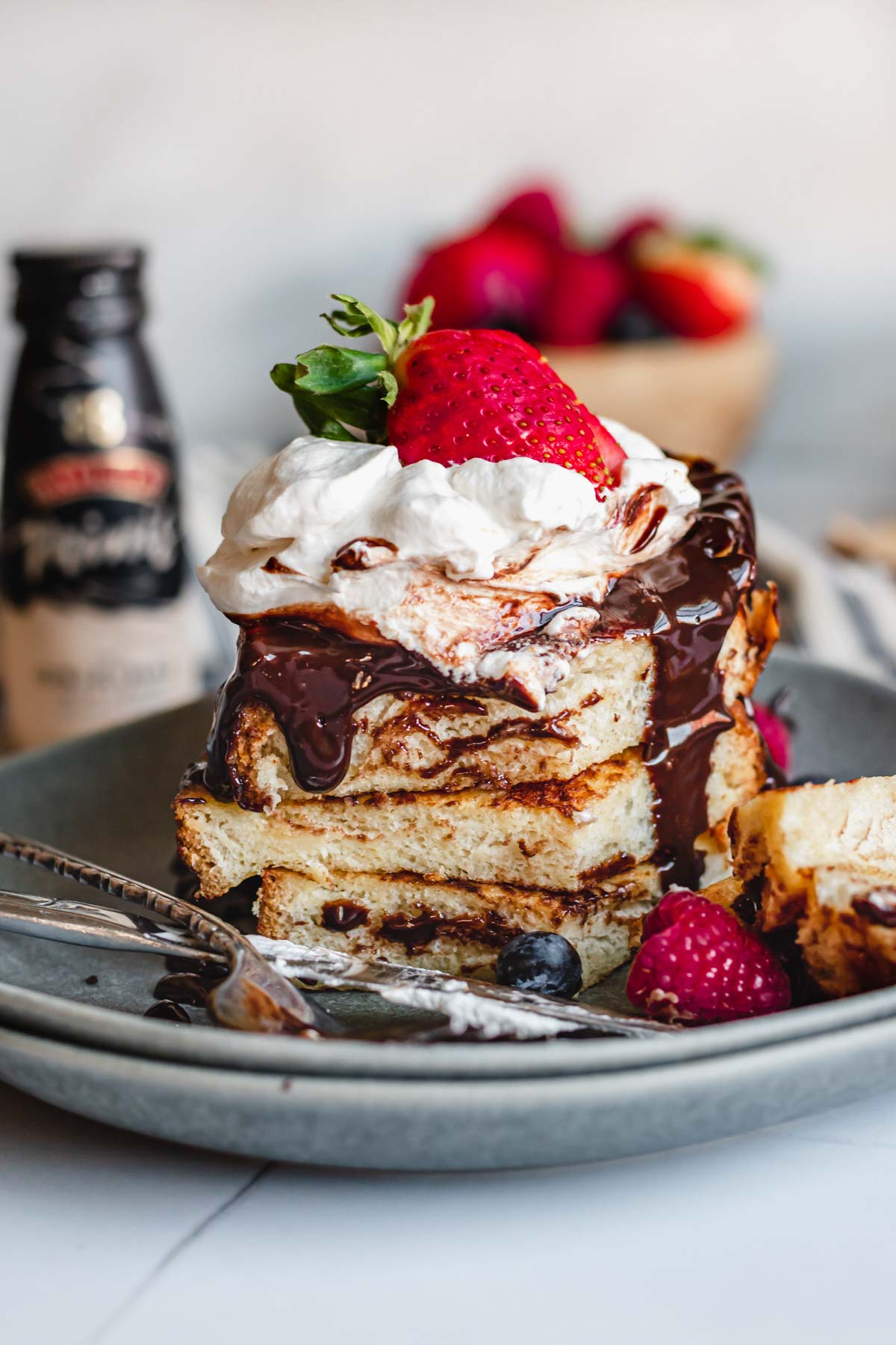 Stack of French toast with a slice removed.