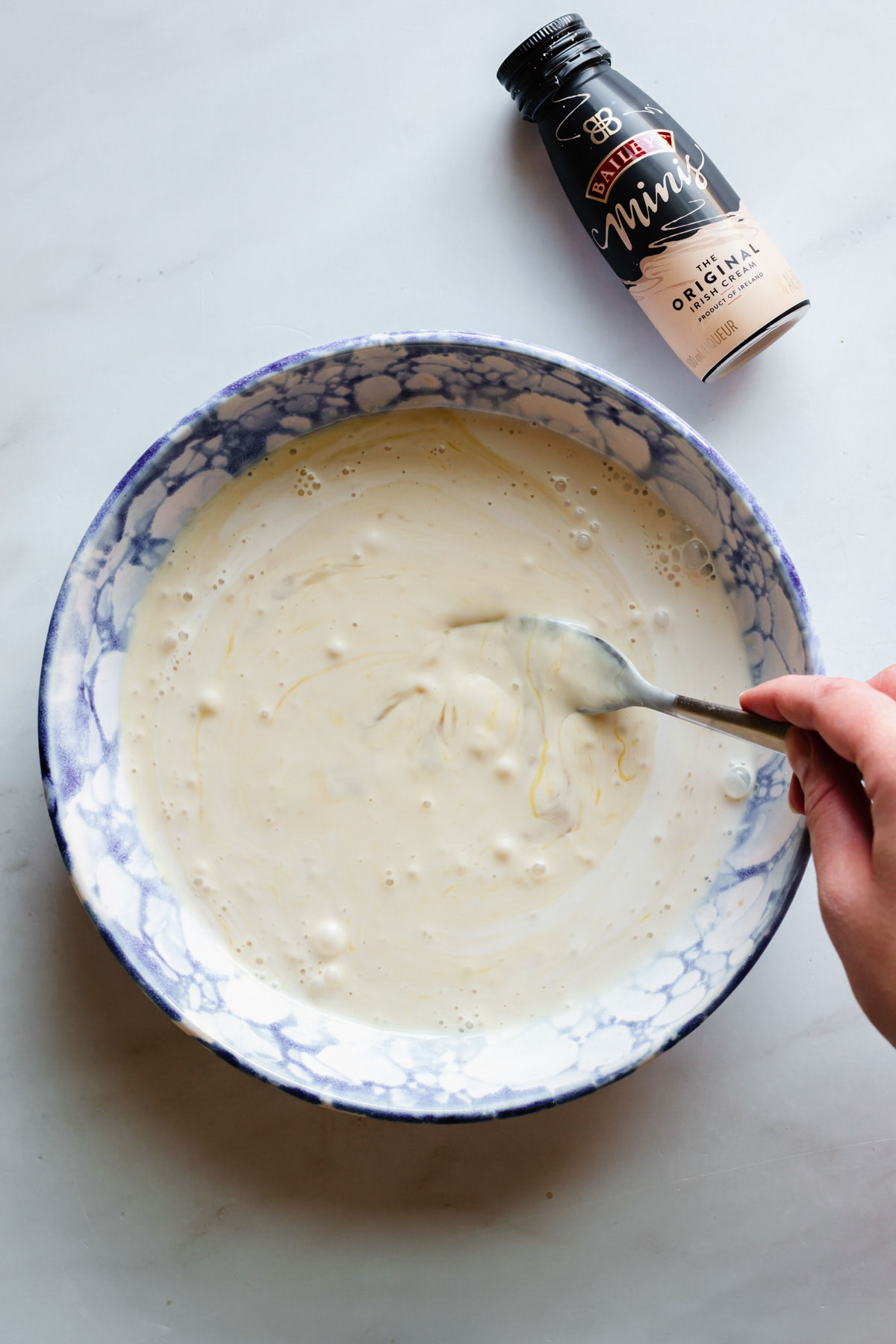 Whisking the custard ingredients in a bowl.