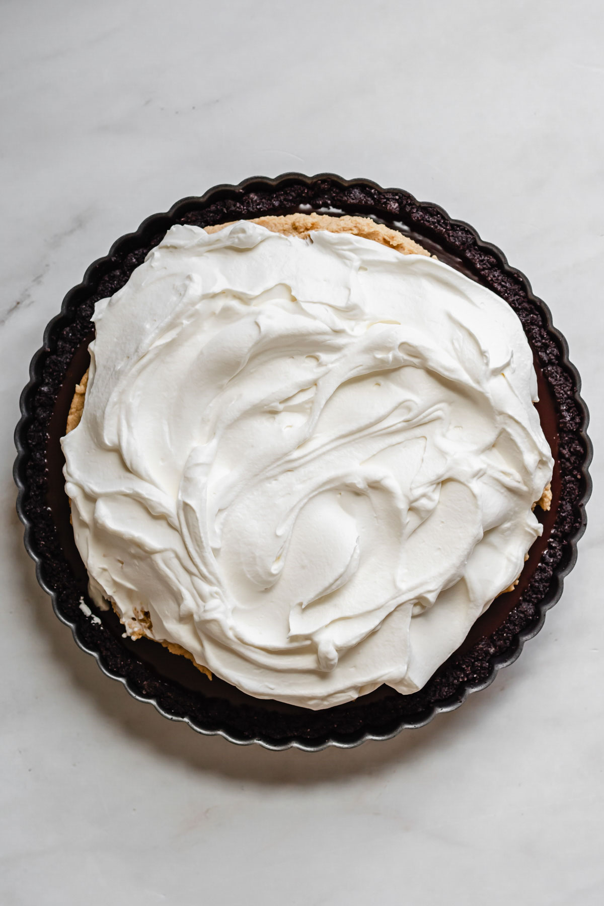 Tart with whipped cream spread on top.