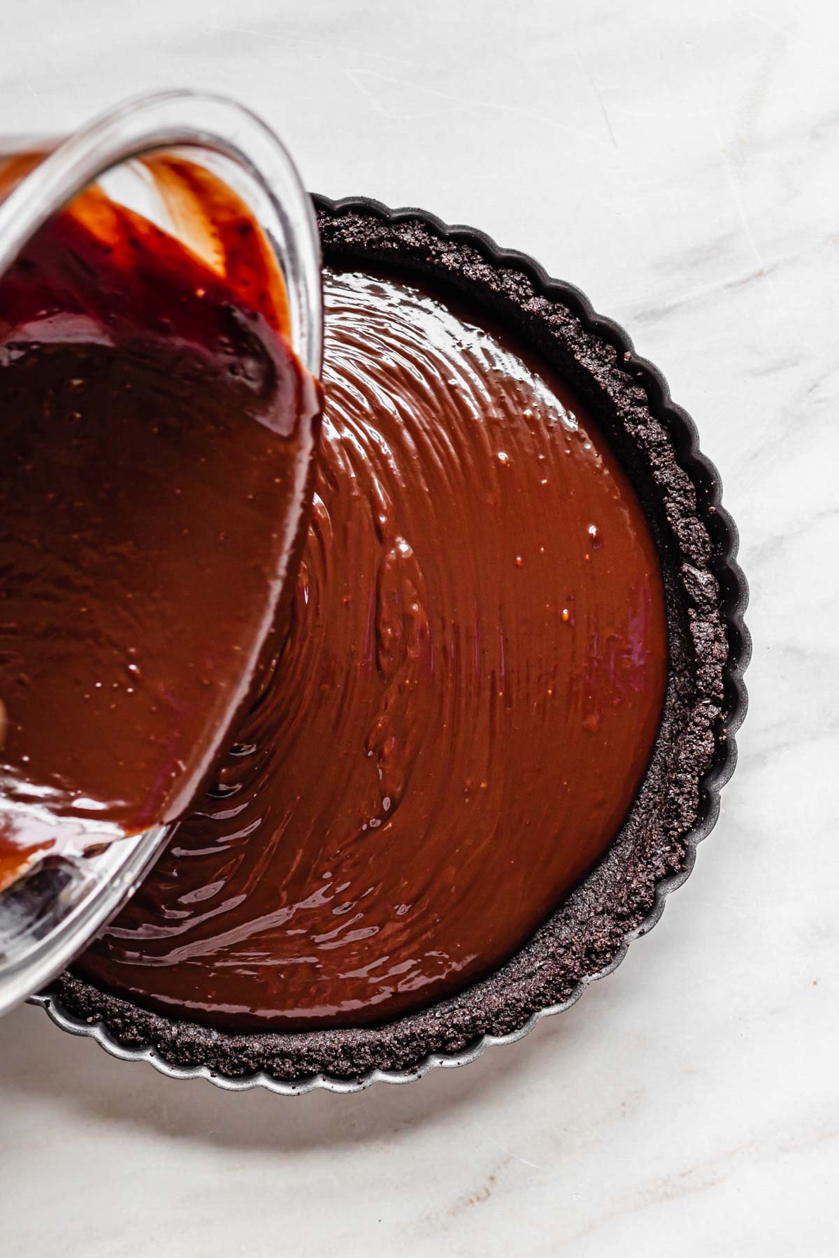 Ganache pouring into the tart shell.