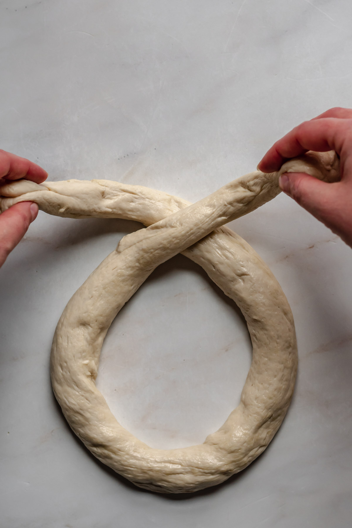 Pretzel dough being formed into a pretzel.