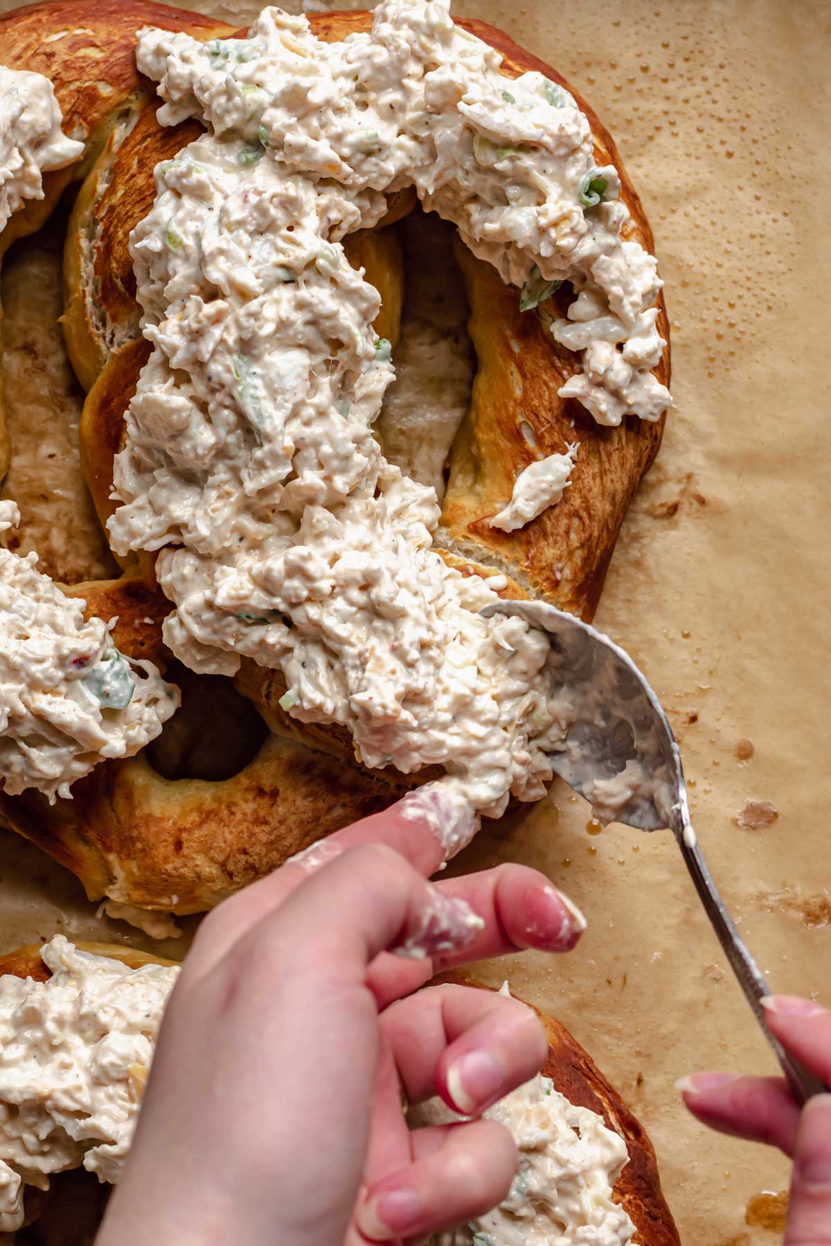 Crab dip spooned onto soft pretzels.