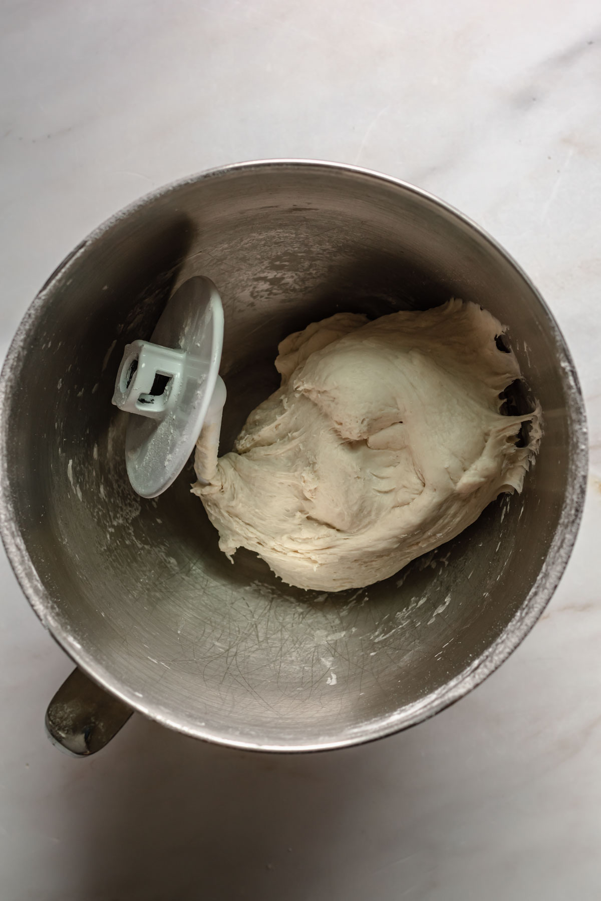 Dough in a bowl with the dough hook.