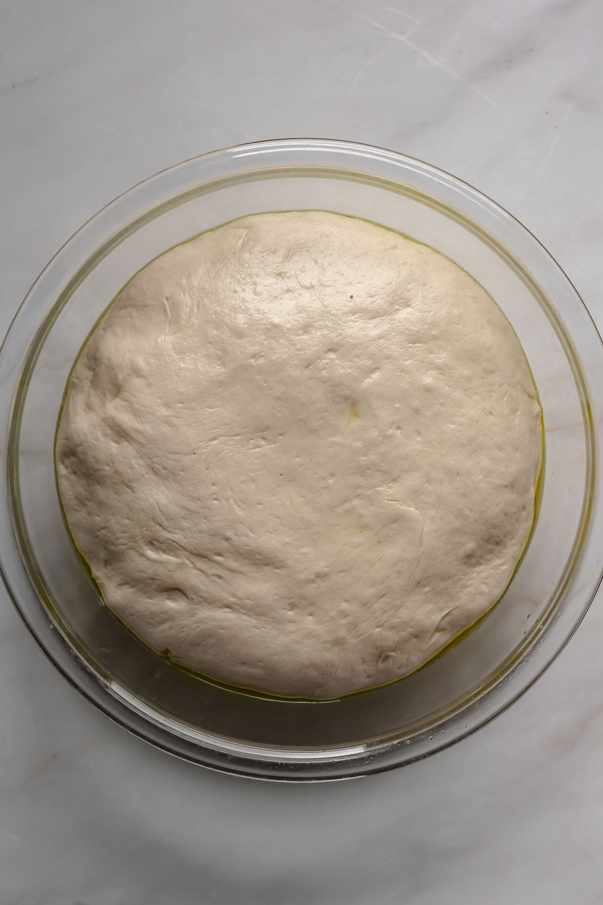 Risen dough filling a bowl.