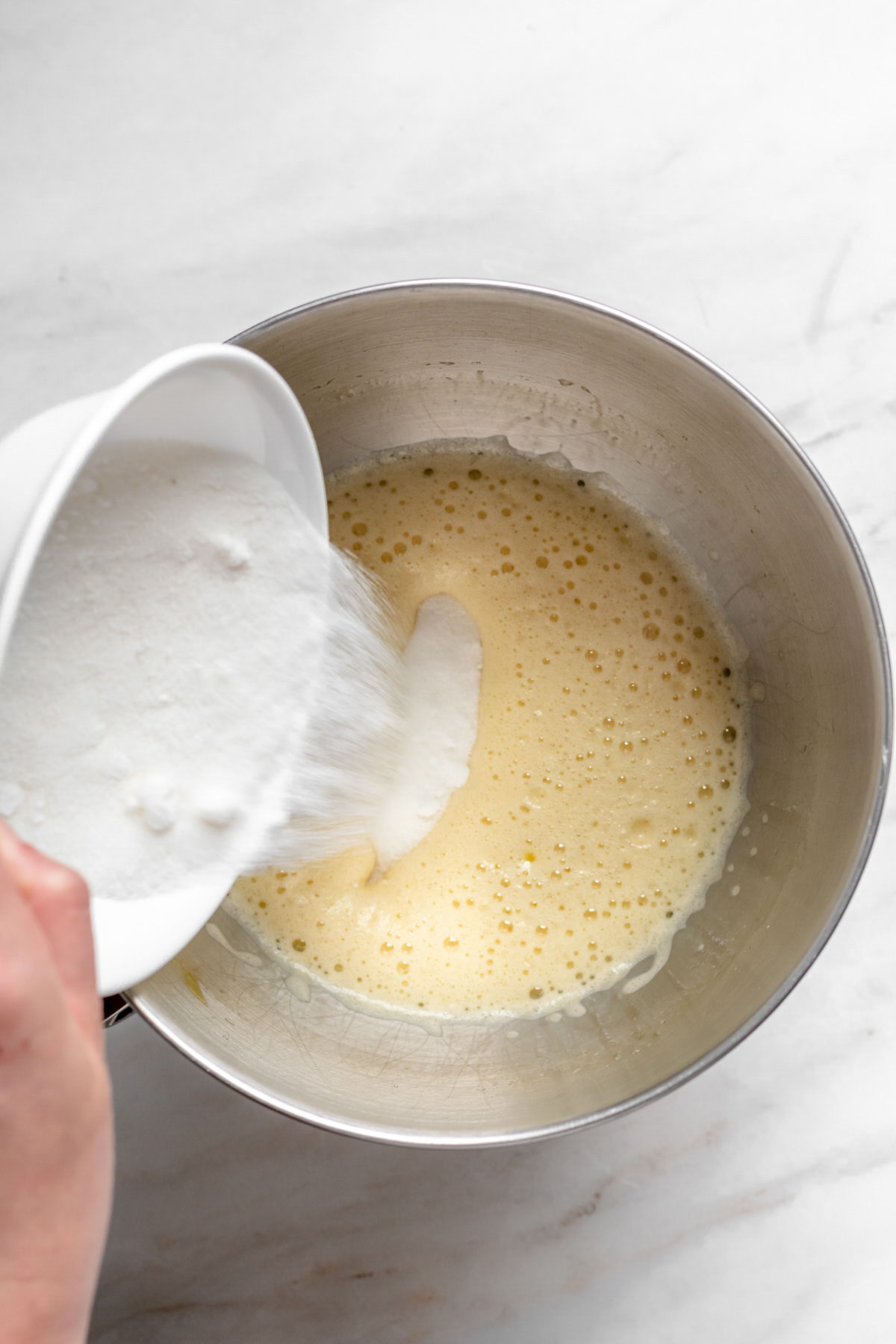 Sugar being added to the batter.
