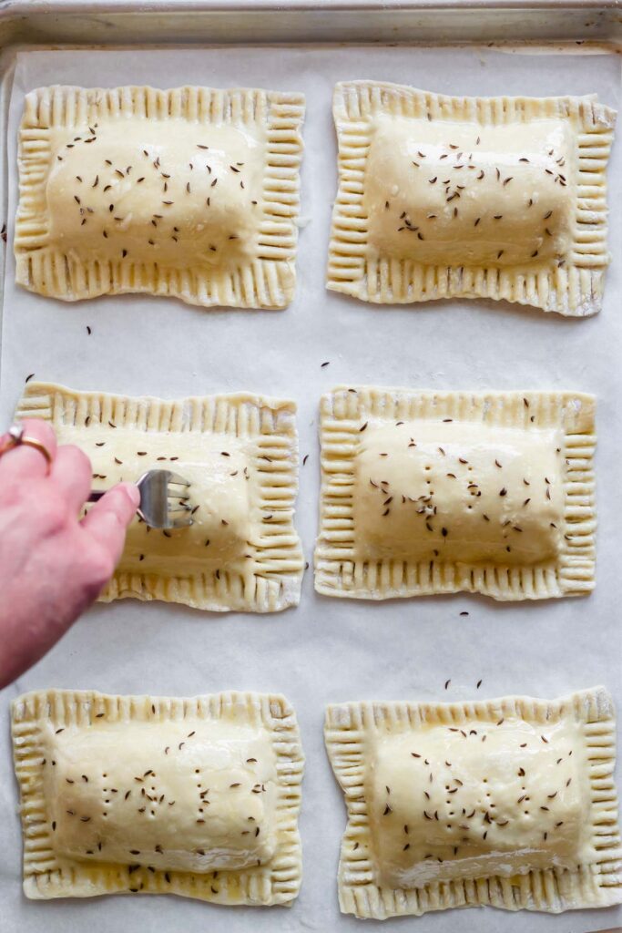 Fork tines poke holes in the hand pies.