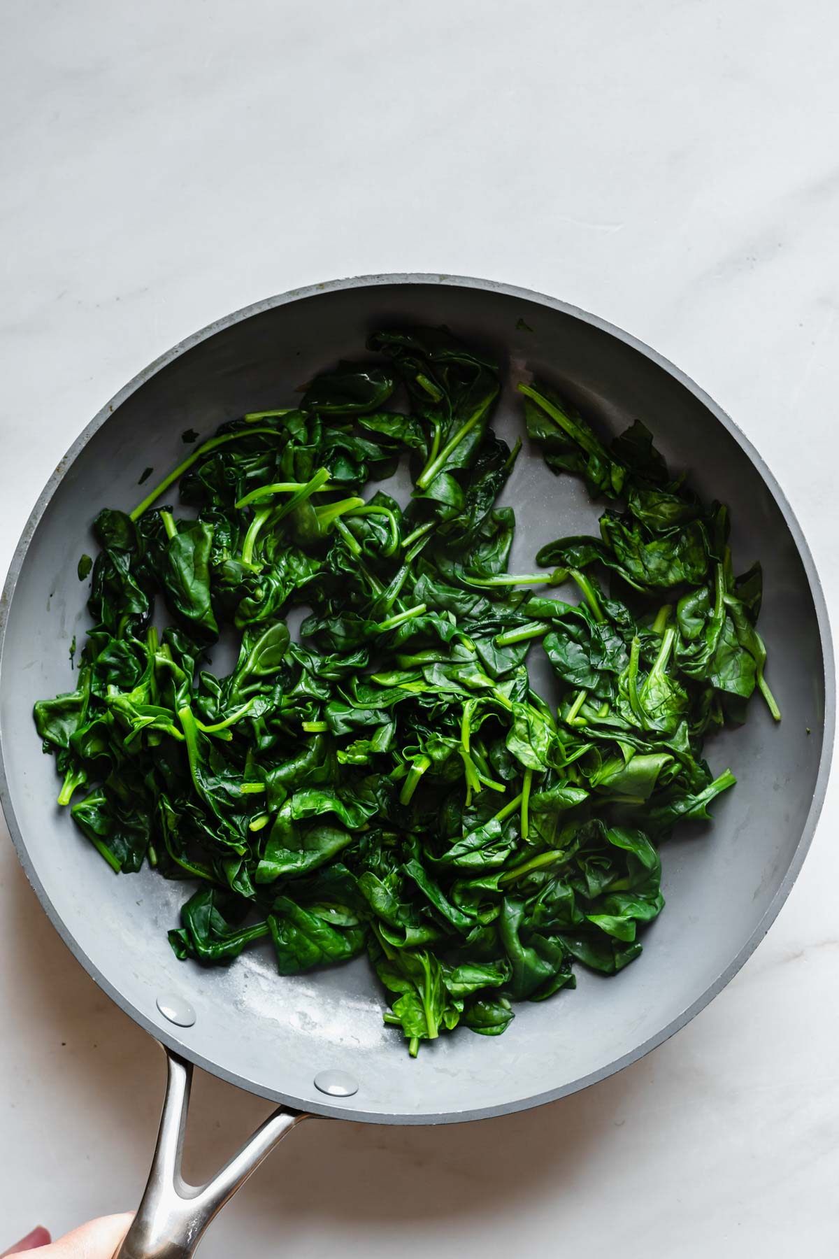 Spinach sauteed in a pan.