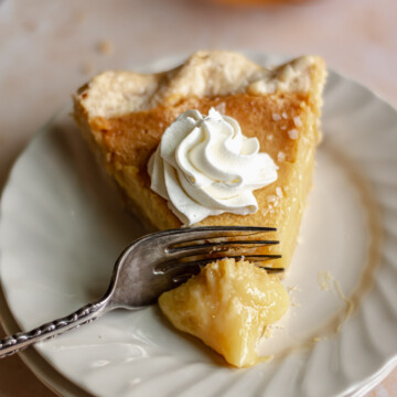 Slice of honey chess pie with a fork removing a slice.
