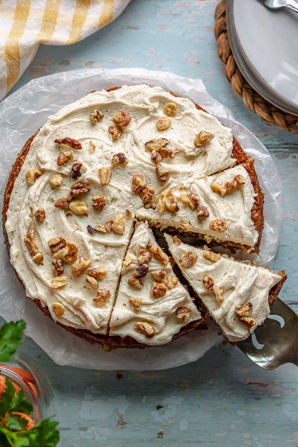 Carrot cake with a slice being removed.