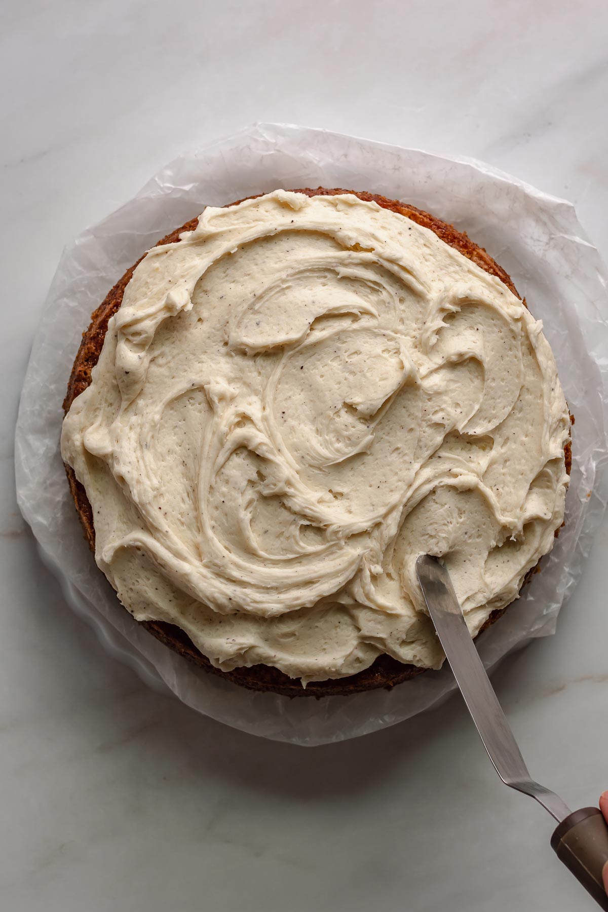 A spatula swoops on the frosting.