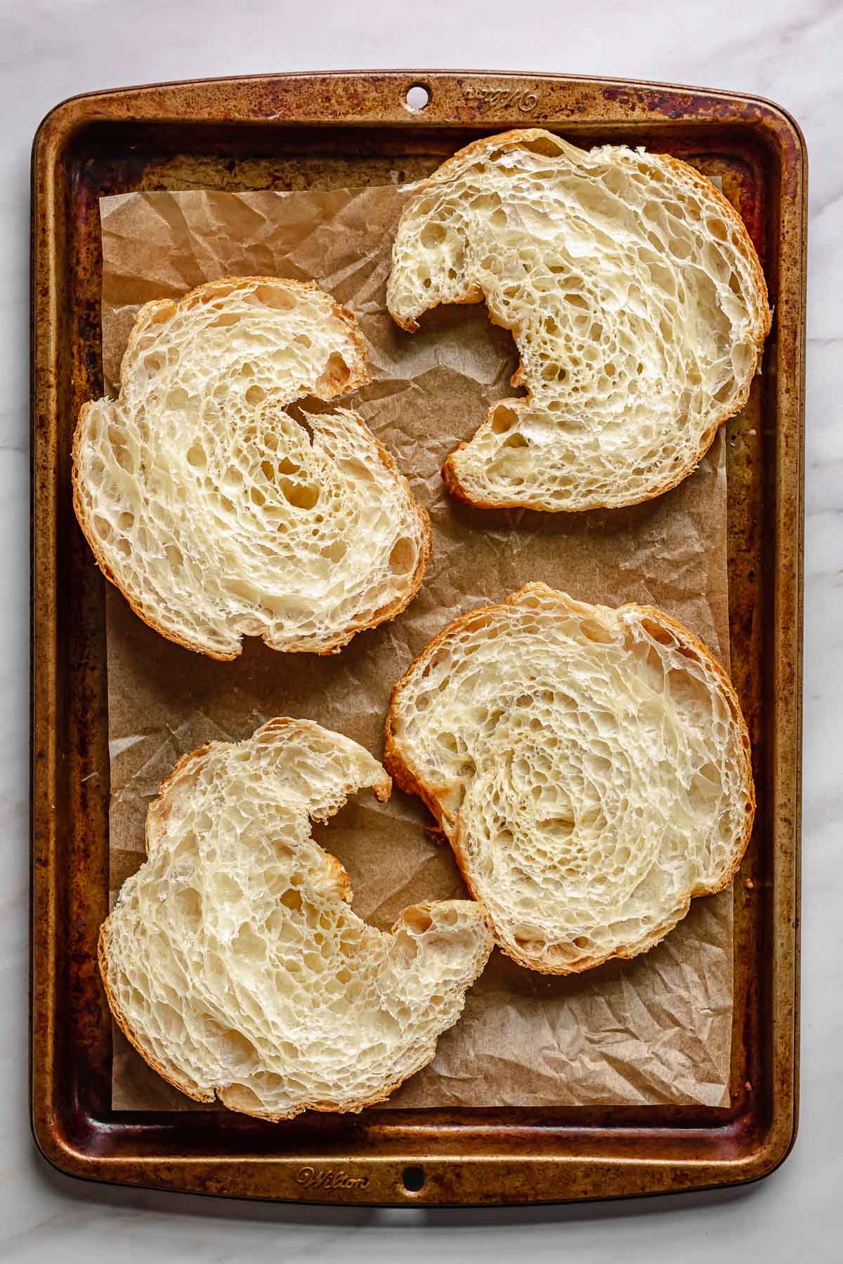 Split croissants on a baking sheet.