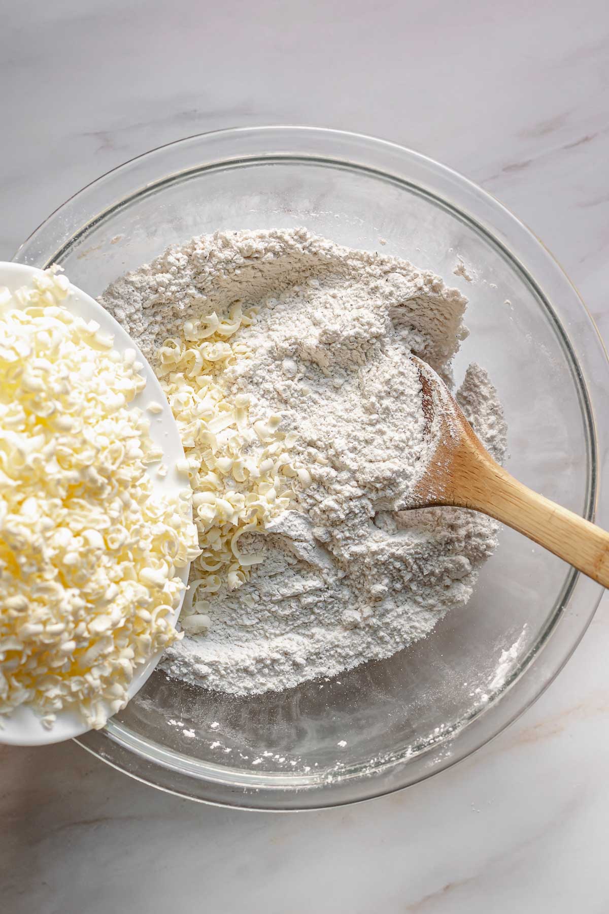 Grated butter being added to flour.