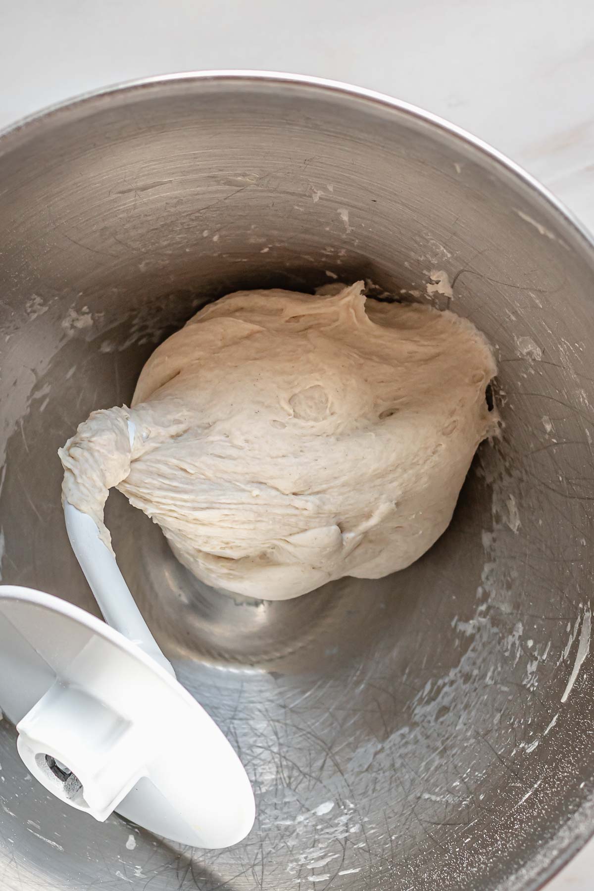 Pretzel dough on a dough hook.