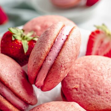 Strawberry whoopie pies on a cake stand.