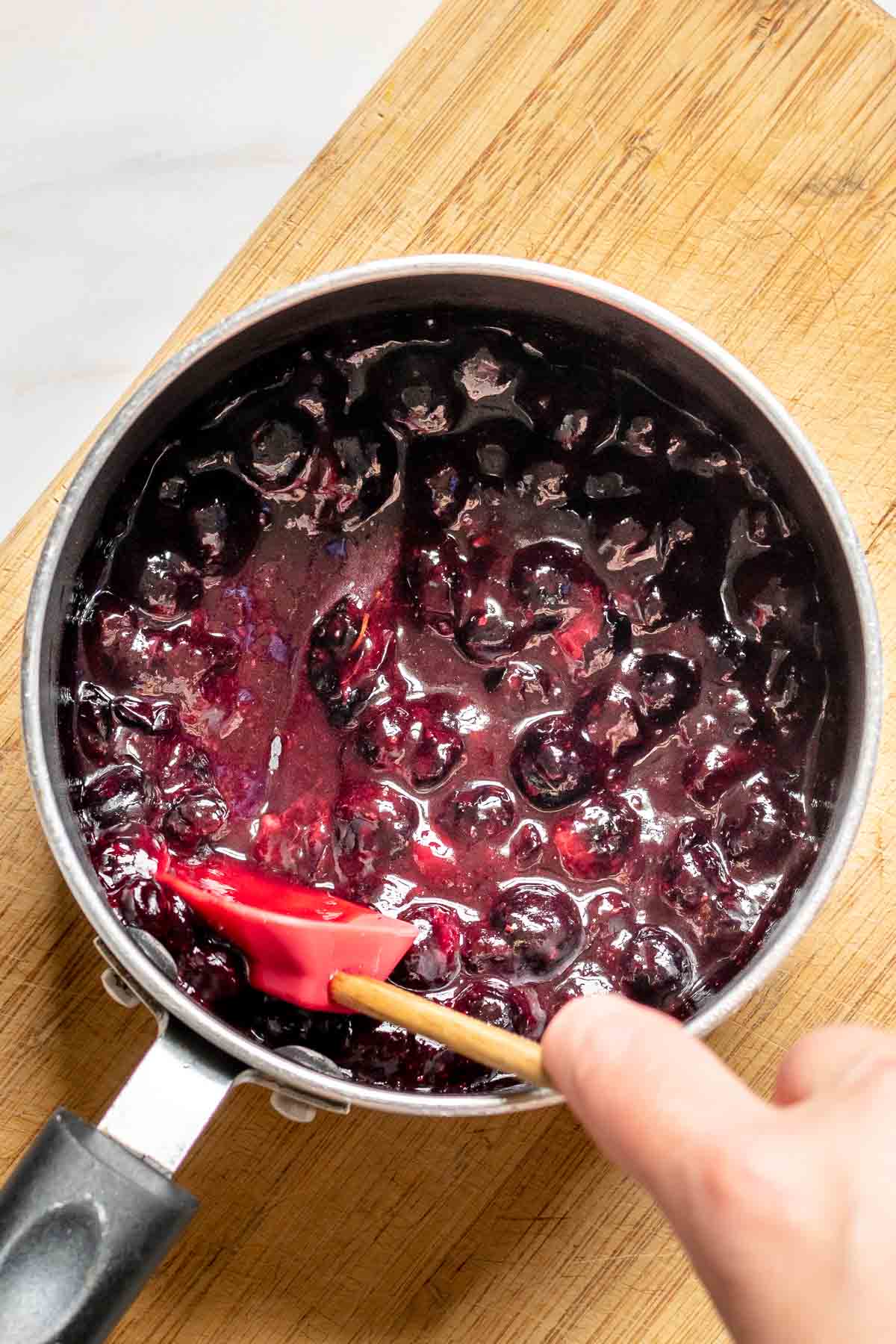 Cooked blueberries in a saucepan.