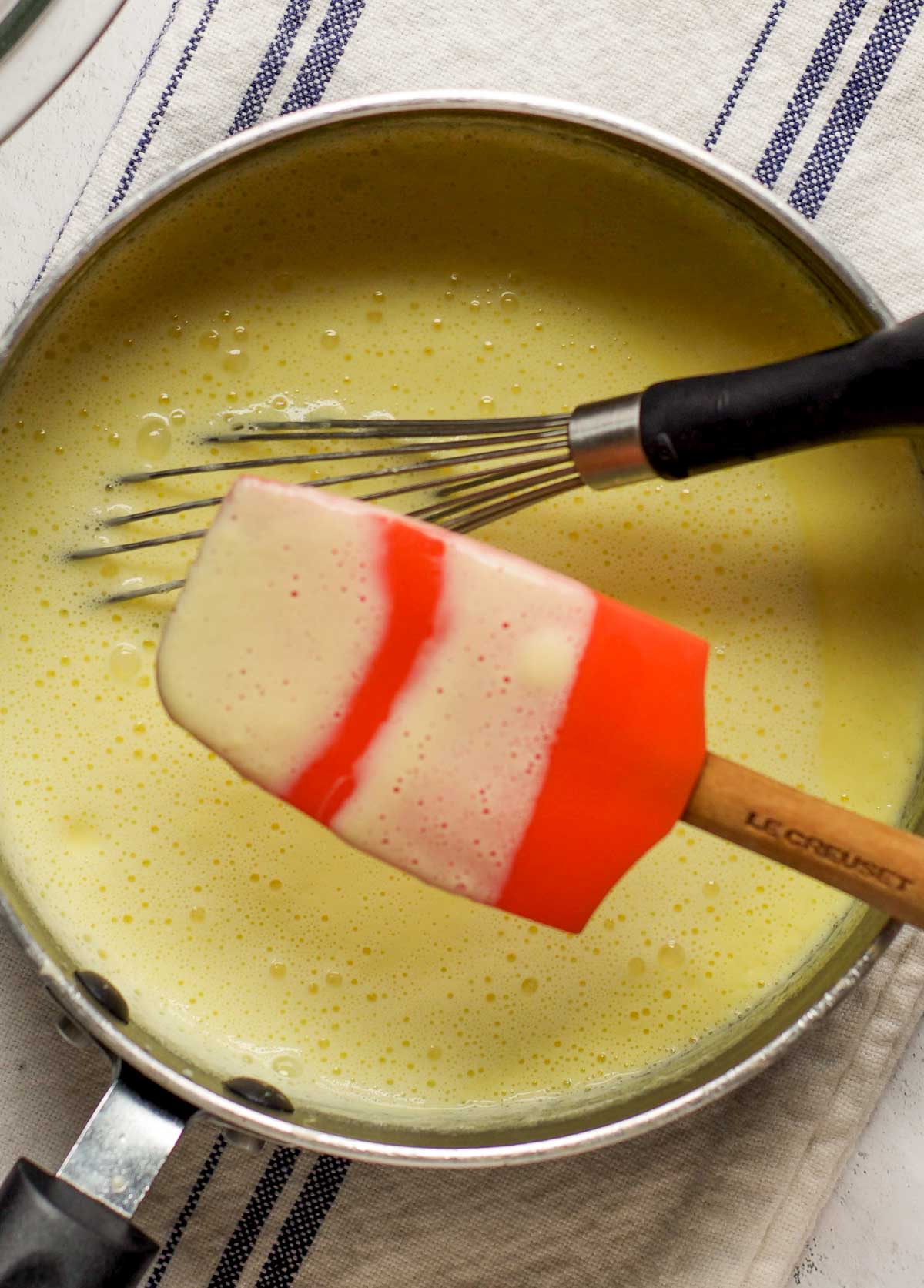 A spatula with custard on it to show thickness.