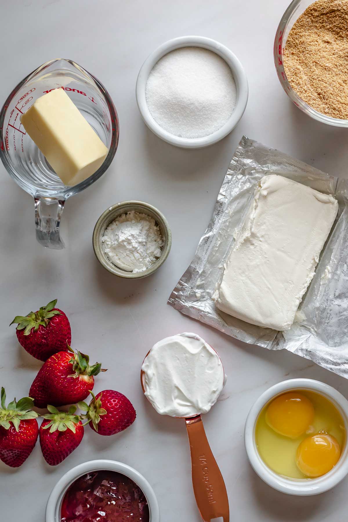Ingredients for mini strawberry cheesecakes.