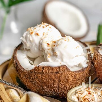 Scoops of coconut sorbet in a coconut shell.