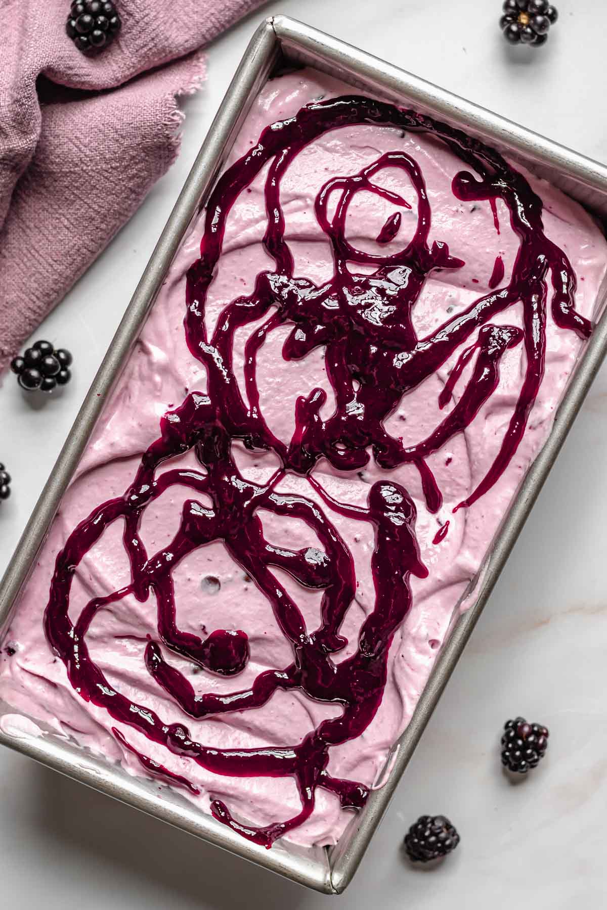 Black raspberry puree drizzled on top of the ice cream.