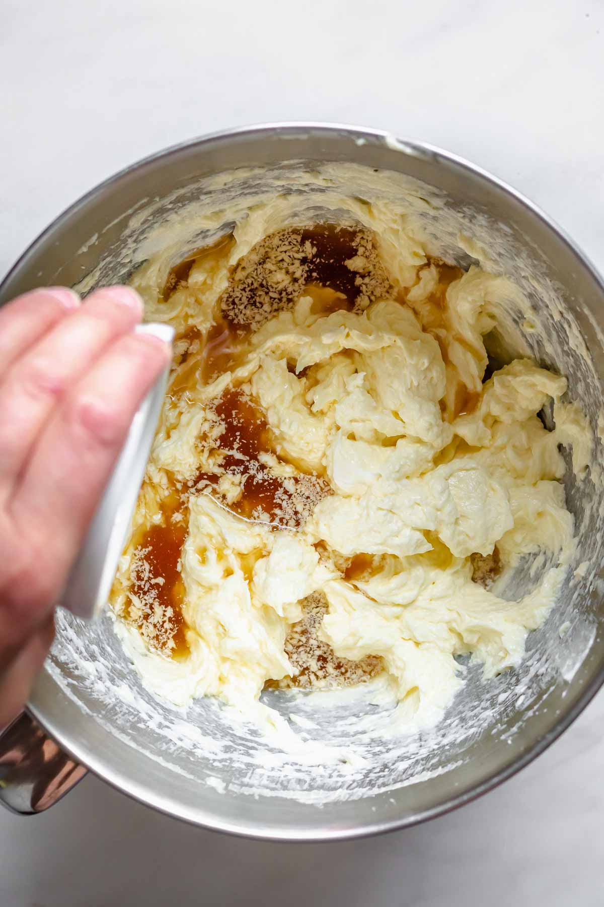 Rum pouring into muffin batter.