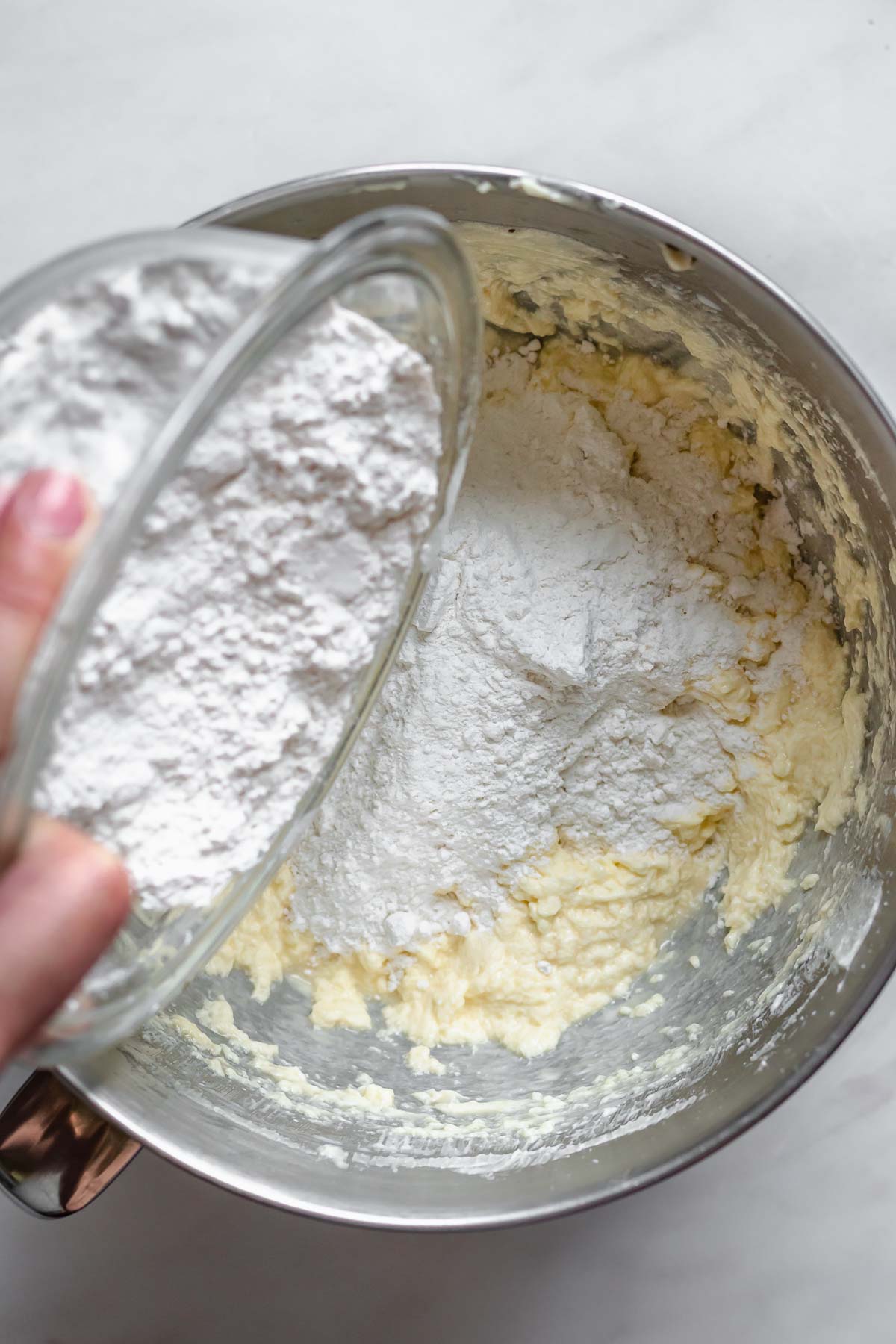 Flour pouring into muffin batter.