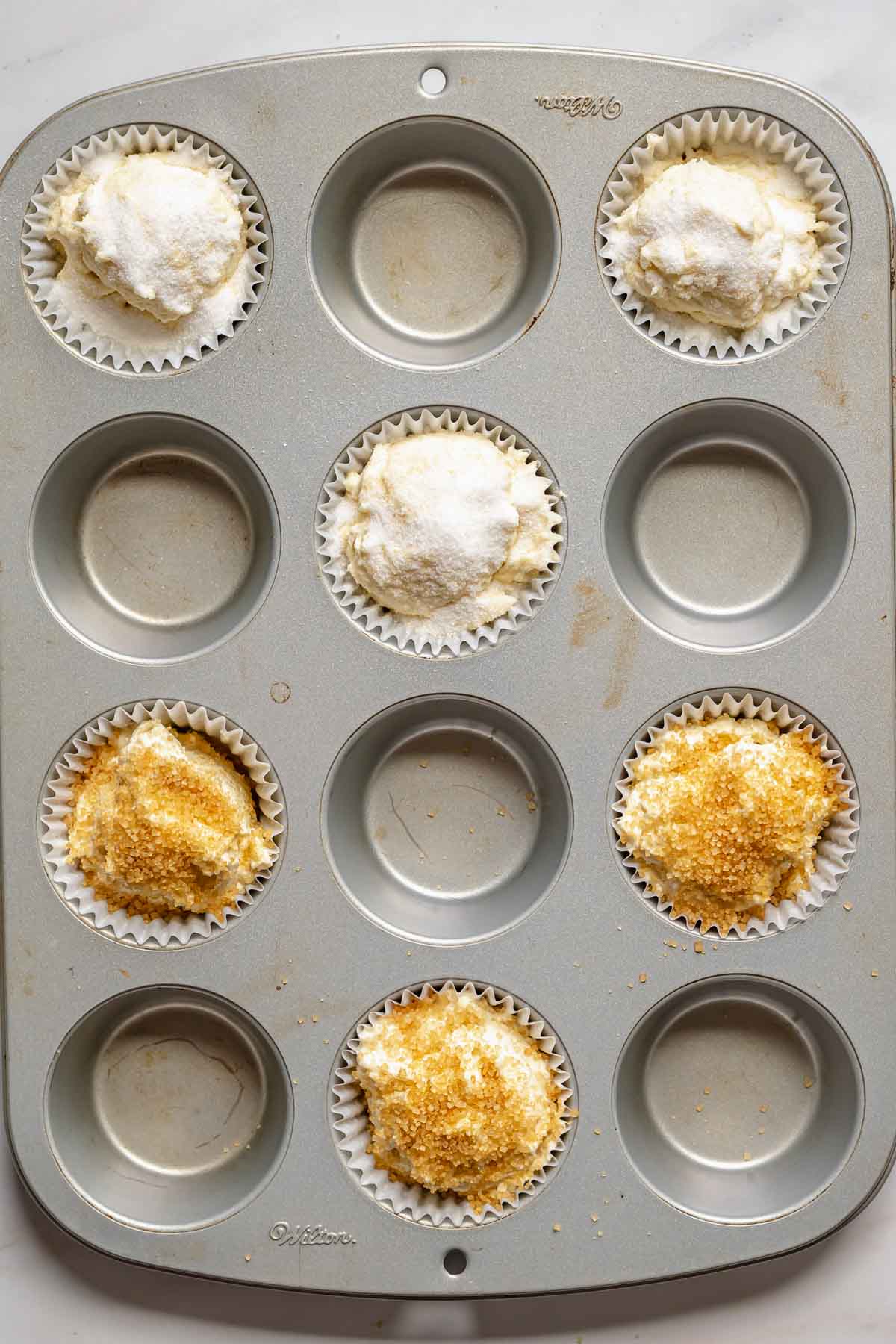Pre-baked muffins topped with sugar.