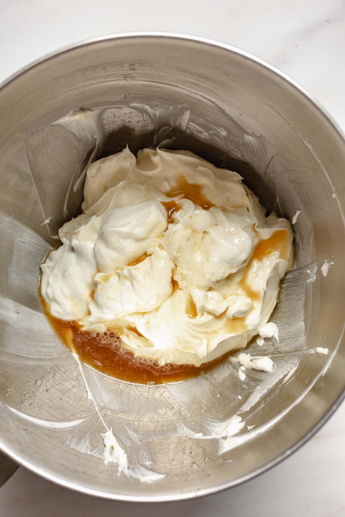 Mixed cream cheese and vanilla in a bowl.