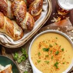 A basket of soft pretzels with beer cheese dip.