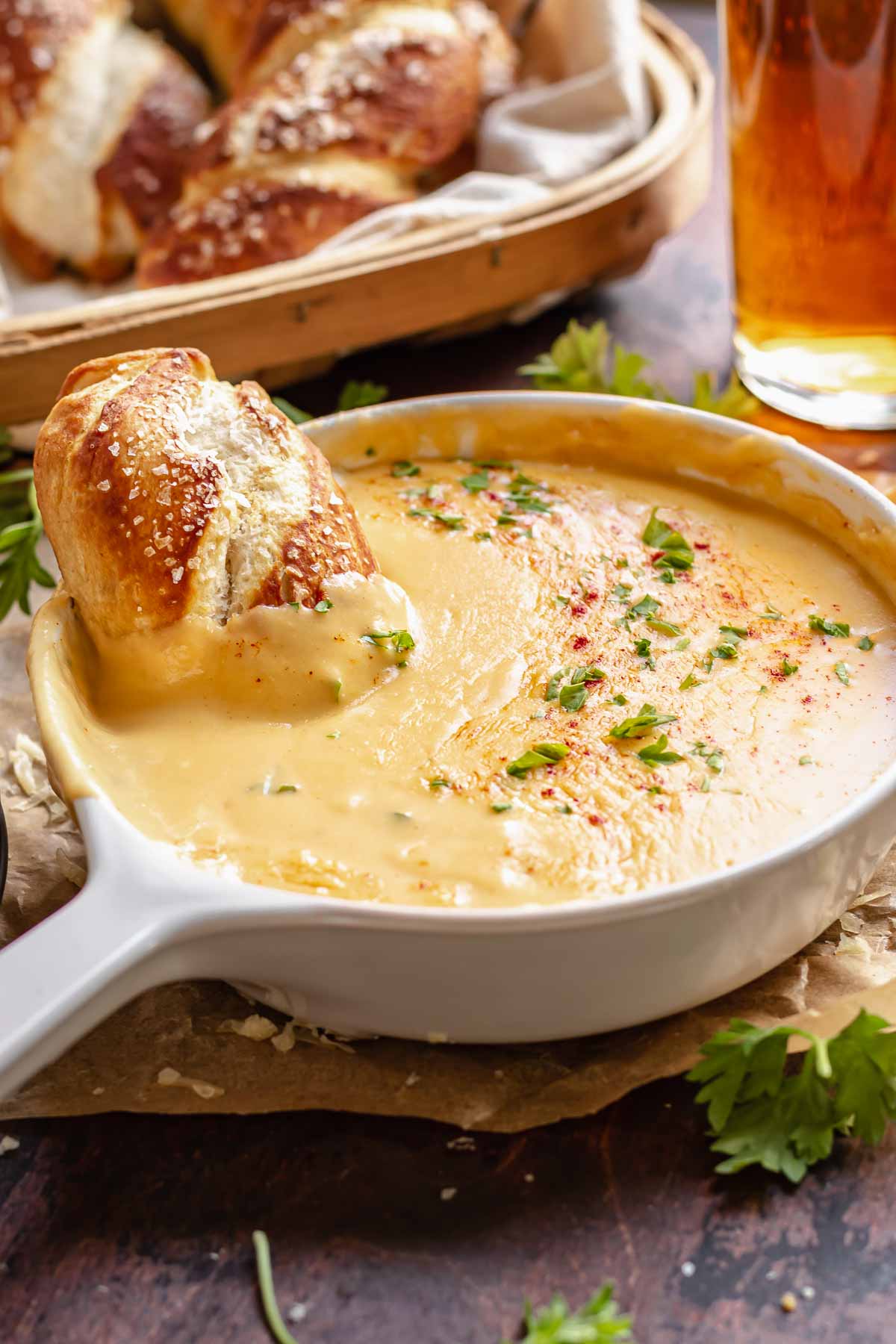 Soft pretzel in a bowl of beer cheese.