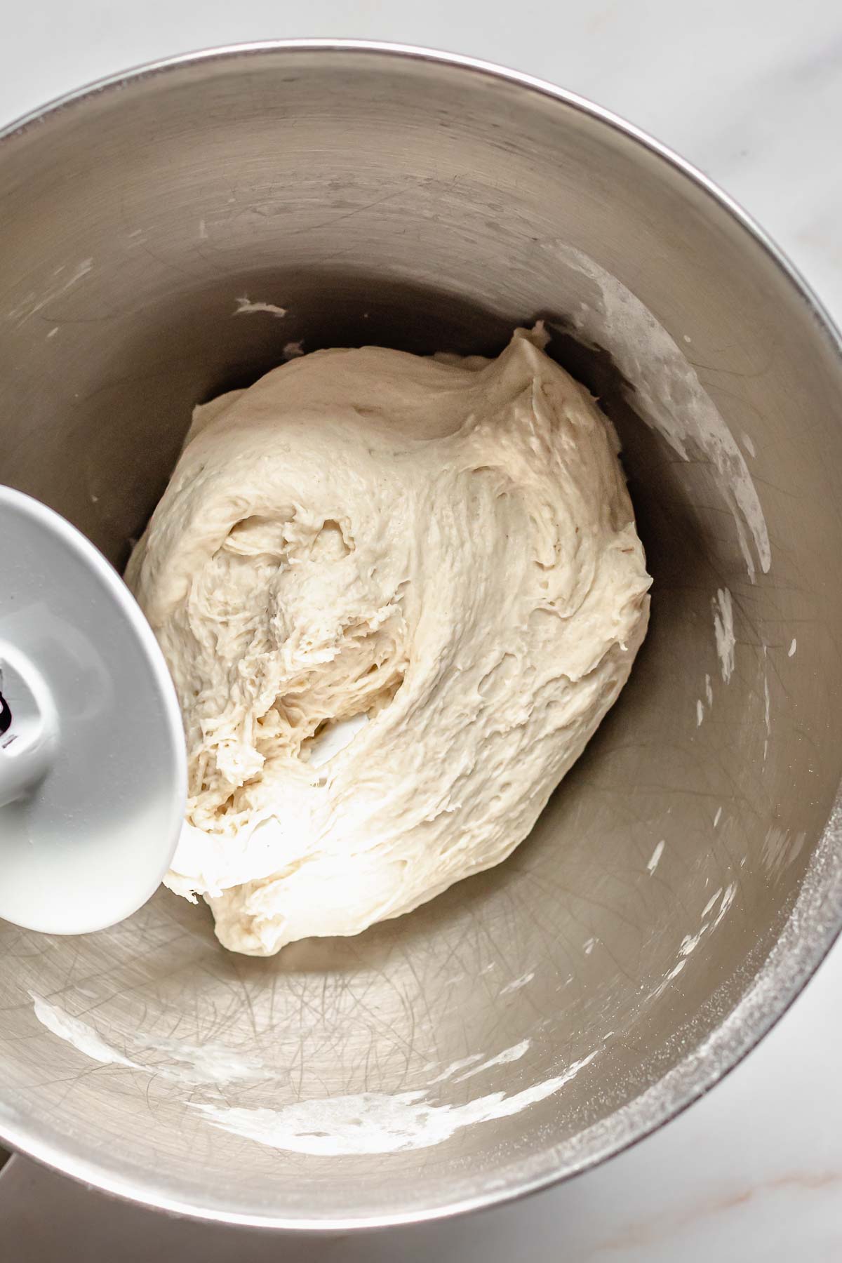Finished pretzel dough in a stand mixer bowl.