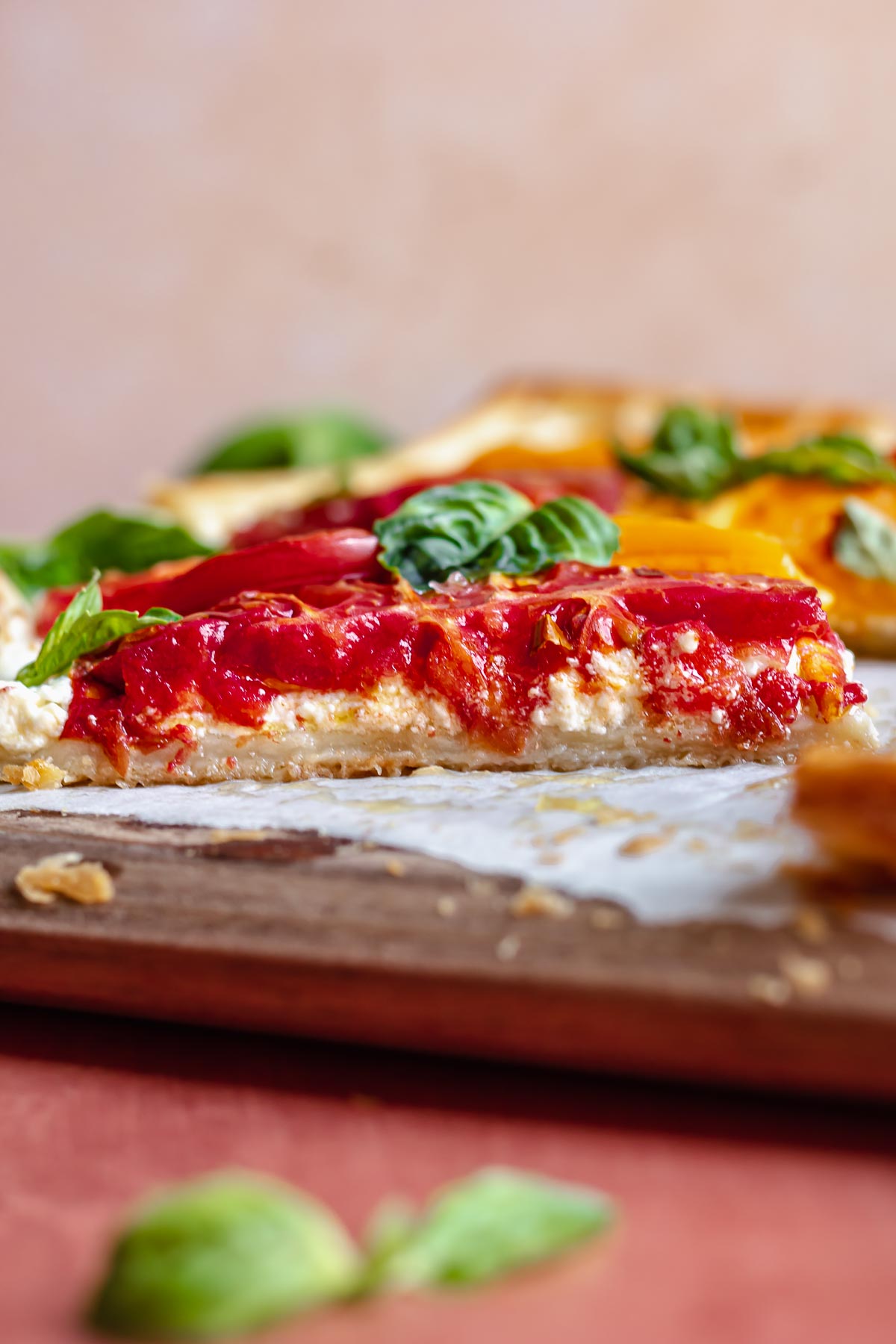 A piece of tomato tart on a cutting board to show the cross section.