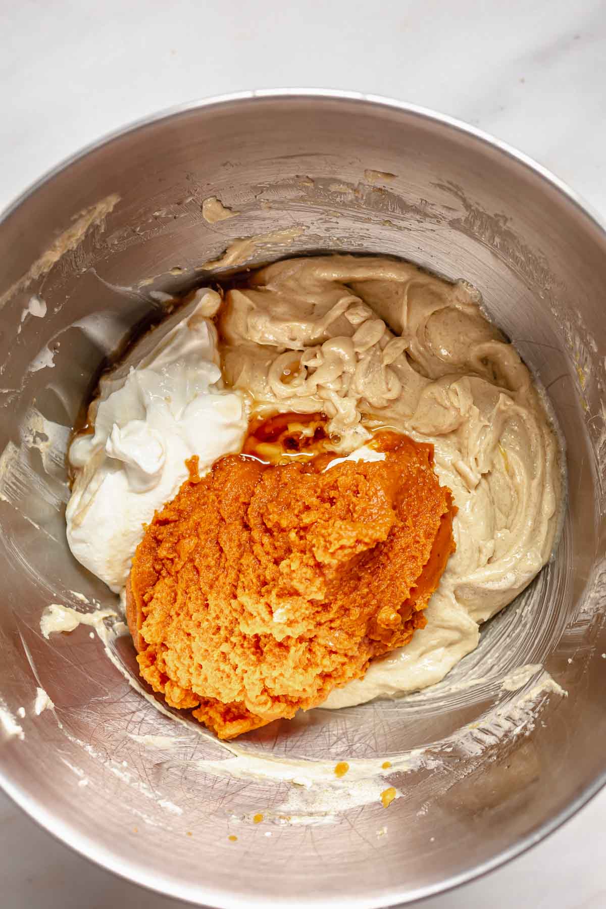 Pumpkin puree and sour cream in the bowl with the batter.