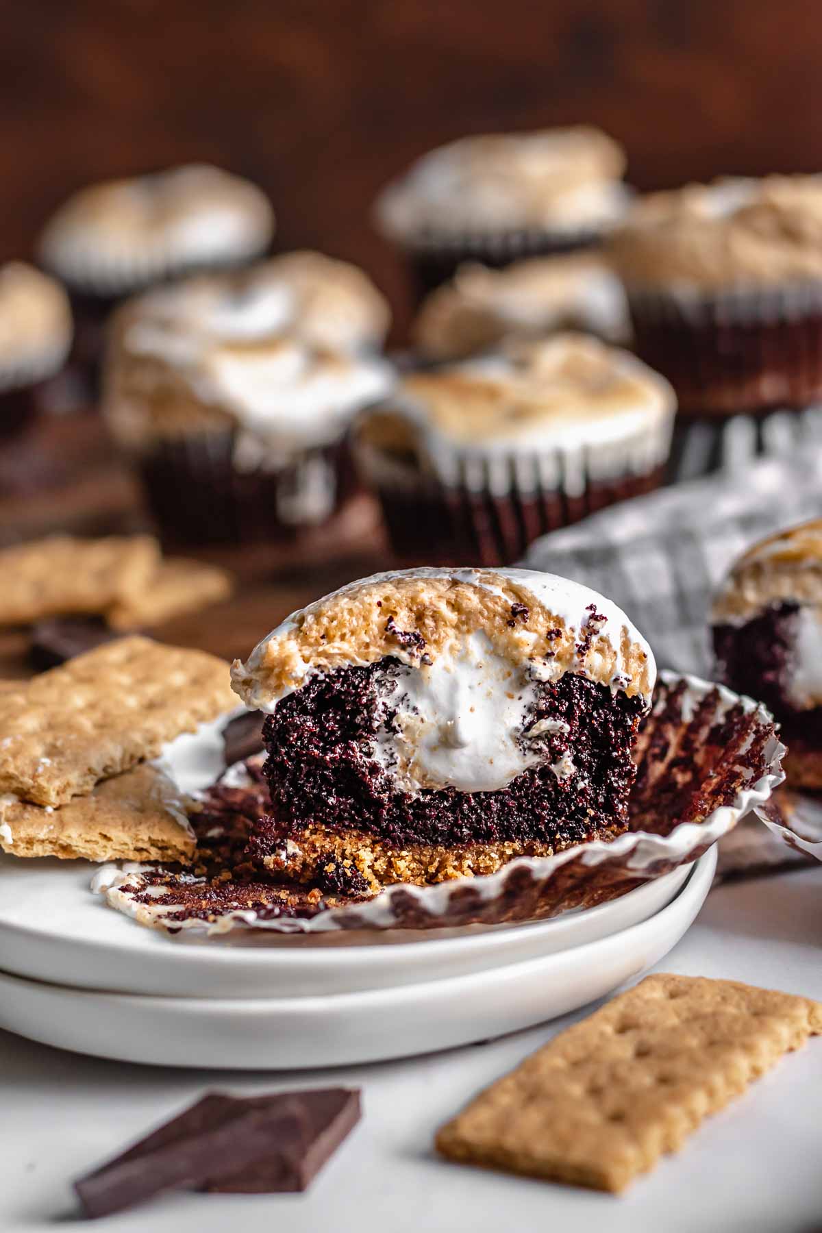 Split open s'mores cupcake on a liner and plate.