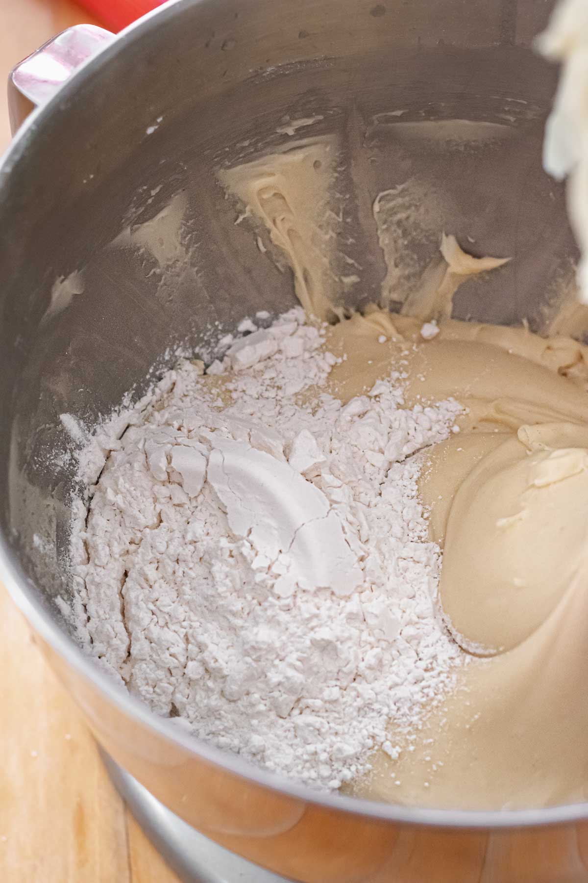 Flour in a stand mixer bowl with brioche dough.