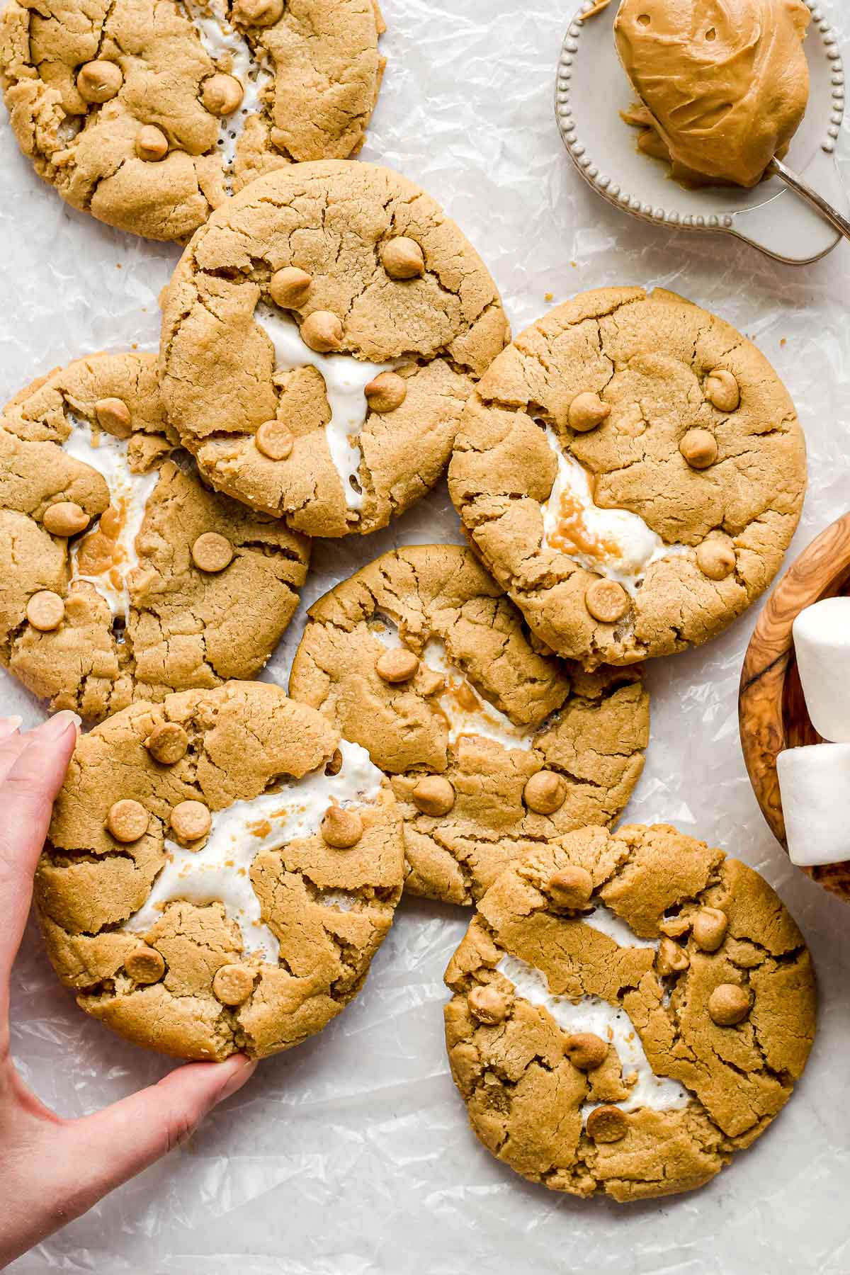 A hand reaches in to take a cookie.