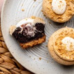 Graham cracker cupcakes on a plate. One is cut in half.