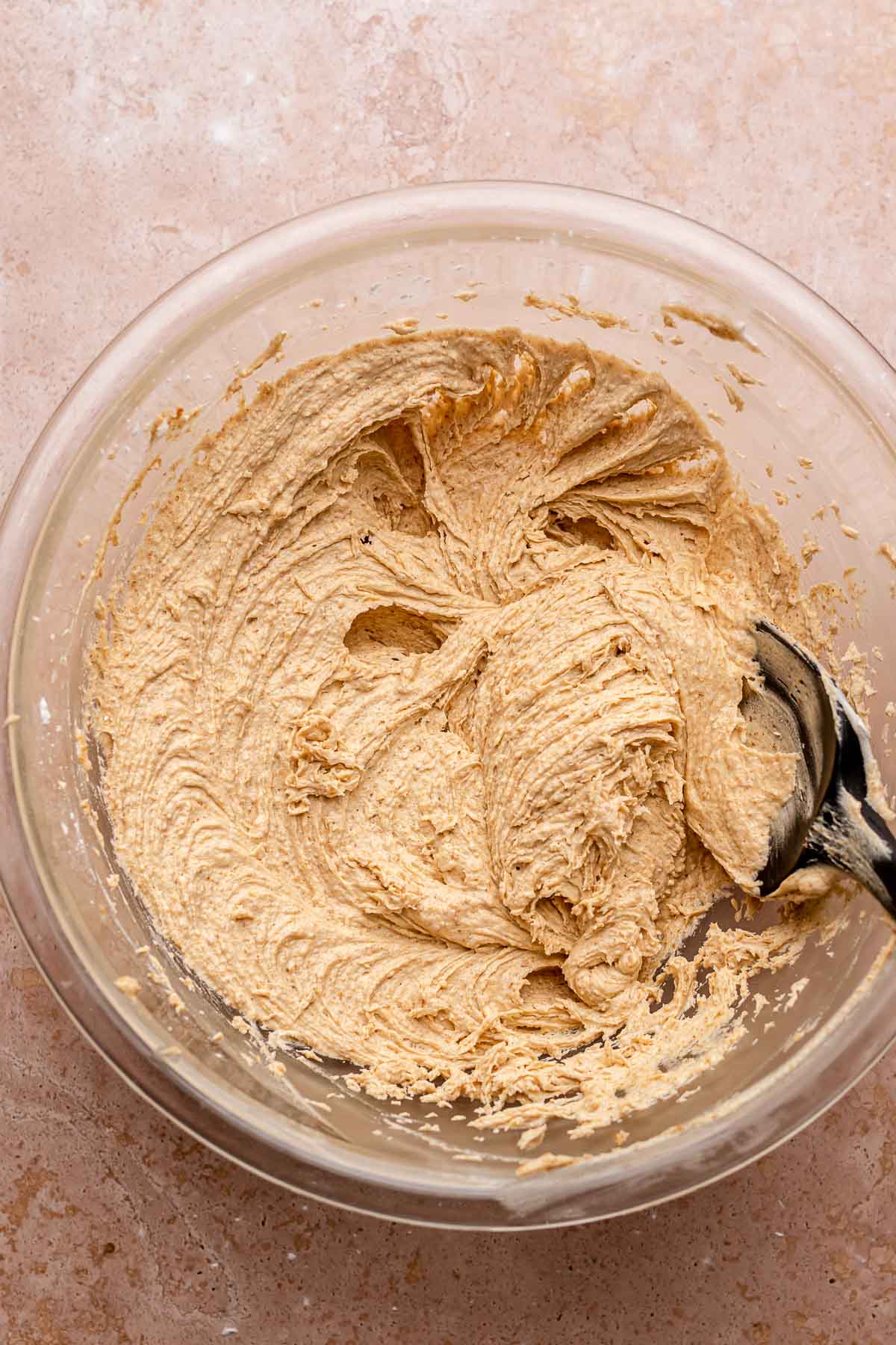 Graham cracker buttercream in a bowl with a spaula on the sude.