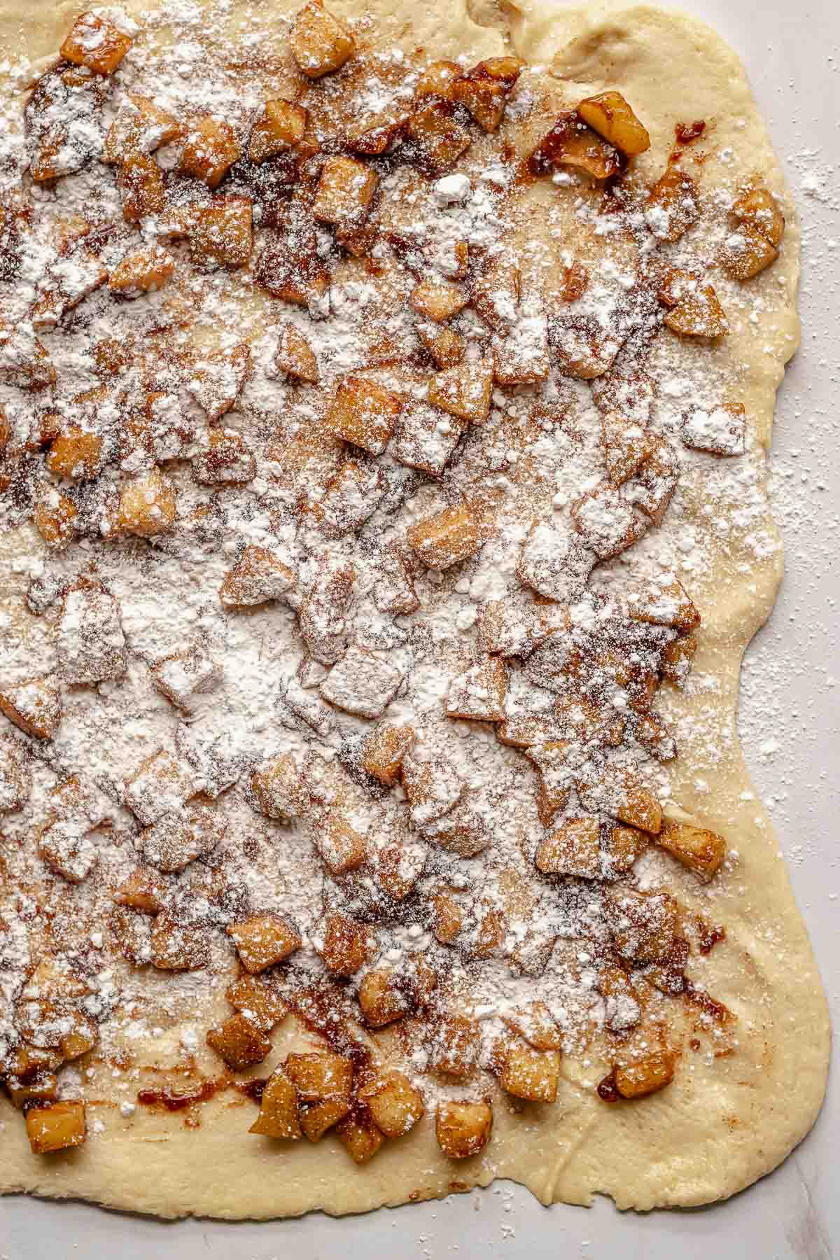 Flour on top of the apples and dough.