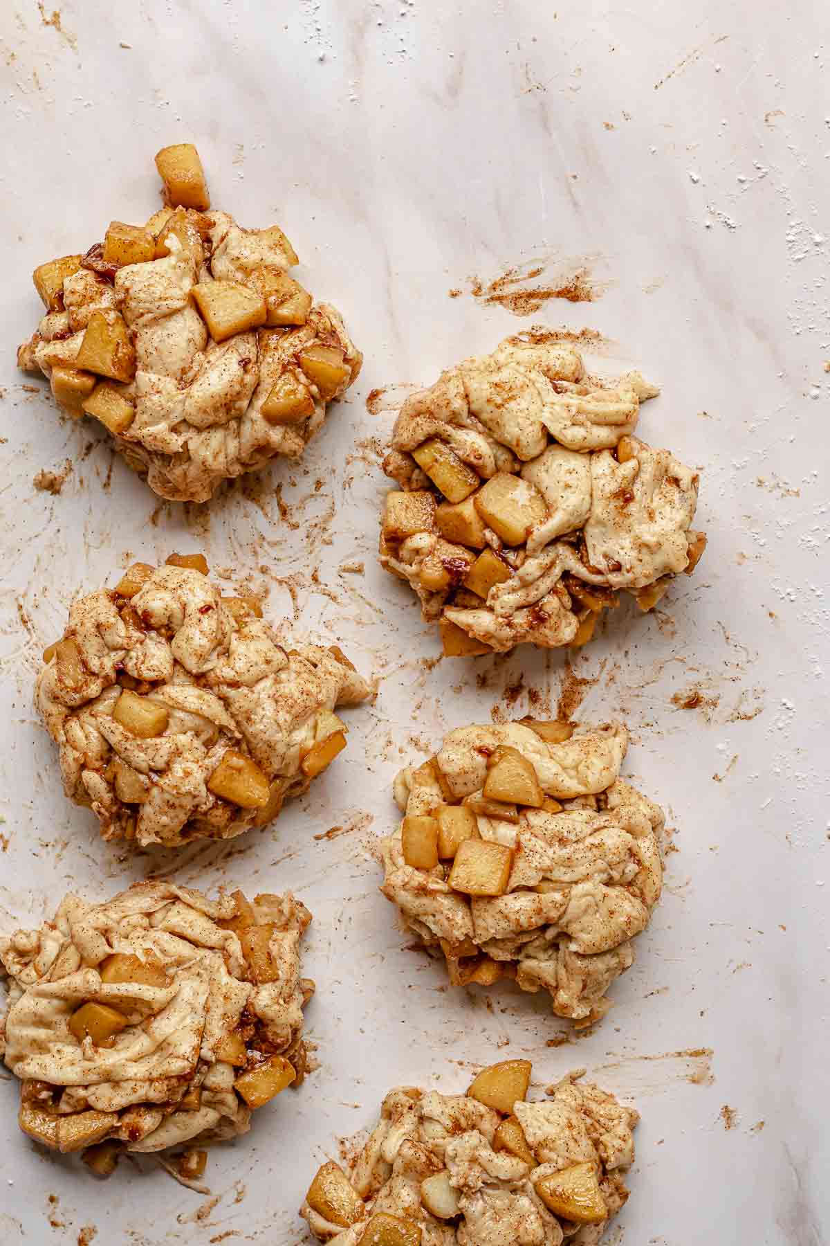 Apple fritter dough formed on a counter.