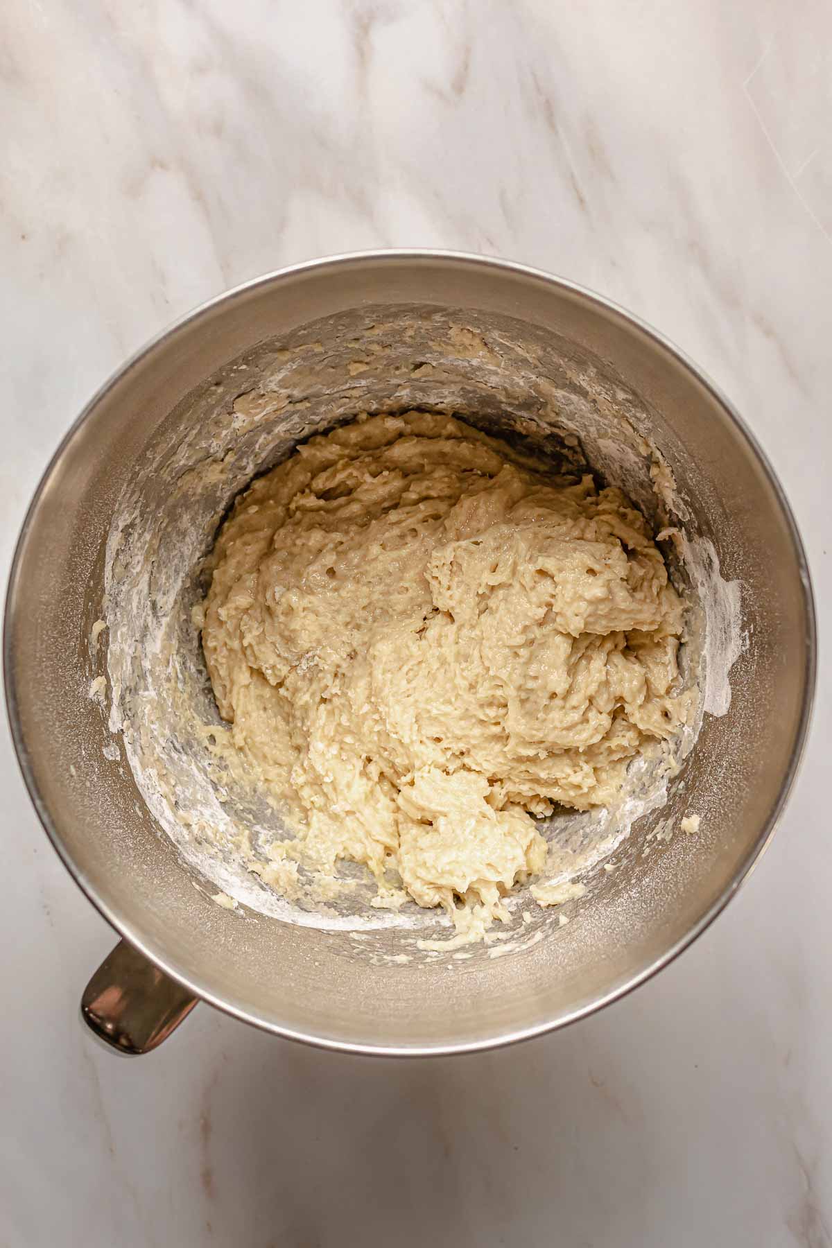 Shaggy brioche dough in a bowl.