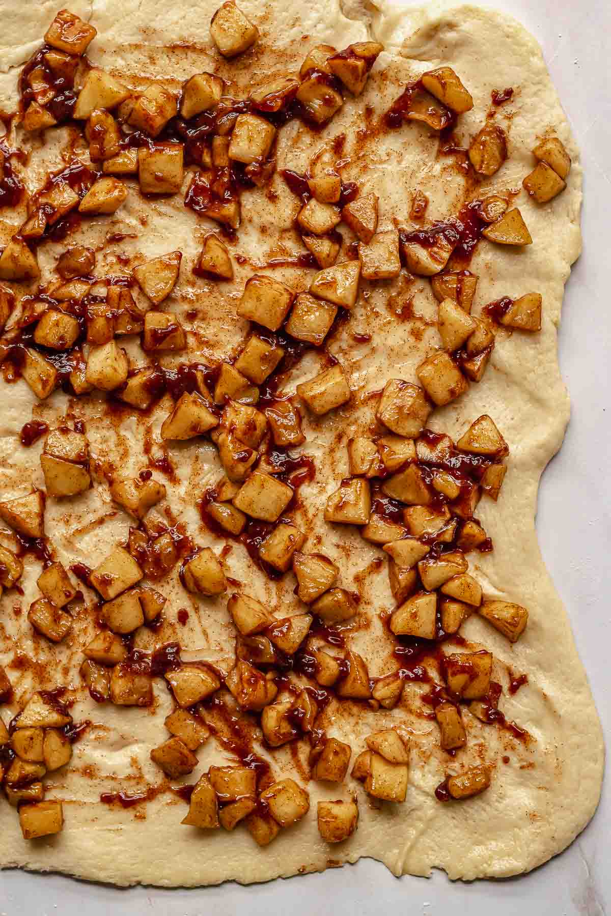 Spiced, diced apples strewn across brioche dough.