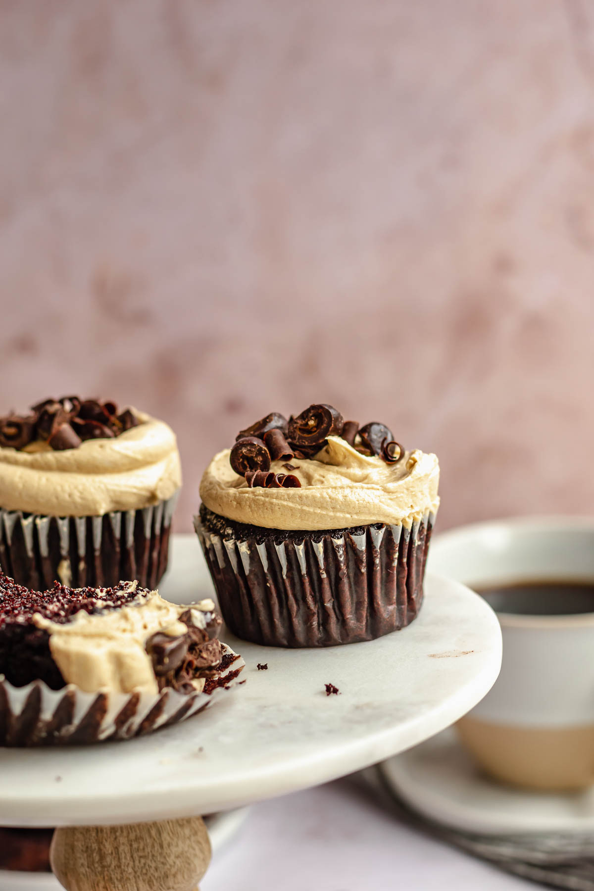 Chocolate coffee cupcakes on a small cake stand.