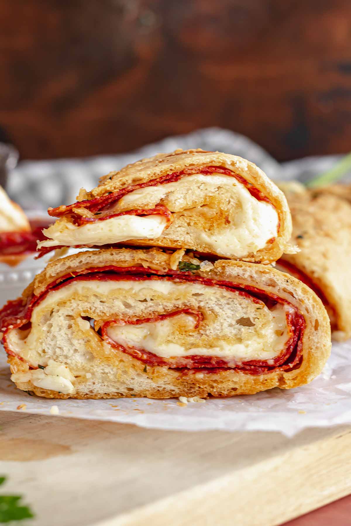 Two pieces of pepperoni bread on top of each other.