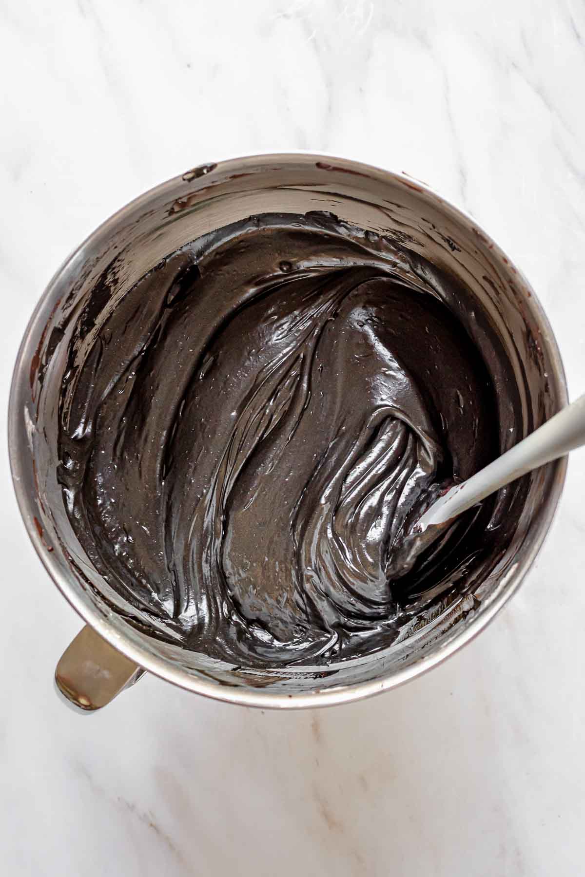 Finished black frosting in a bowl.
