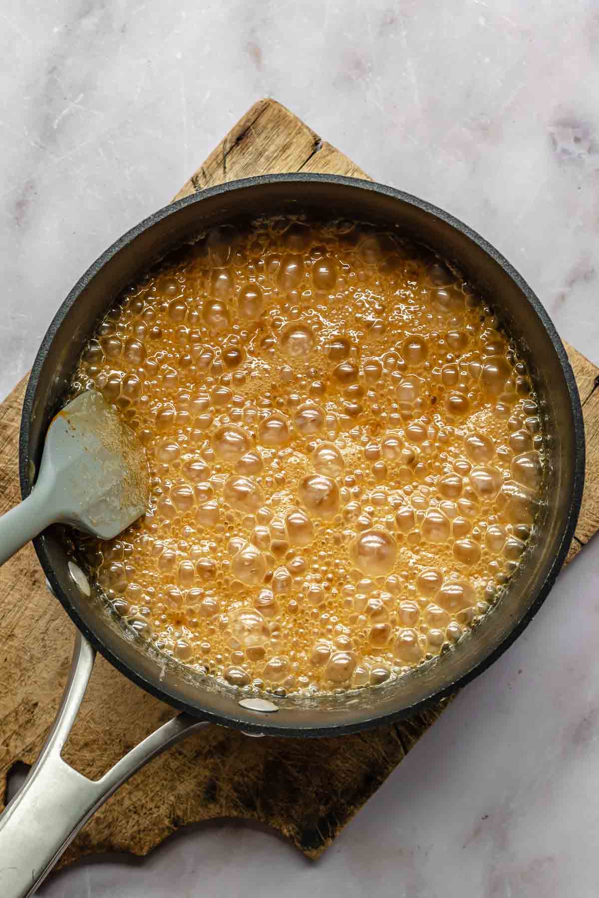 Bubbling caramel in a pot.